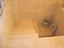 Decending into the bor (pit area) of the Mikvah.   The cover for the second bor is visible on the right.  (24 July, 2005)